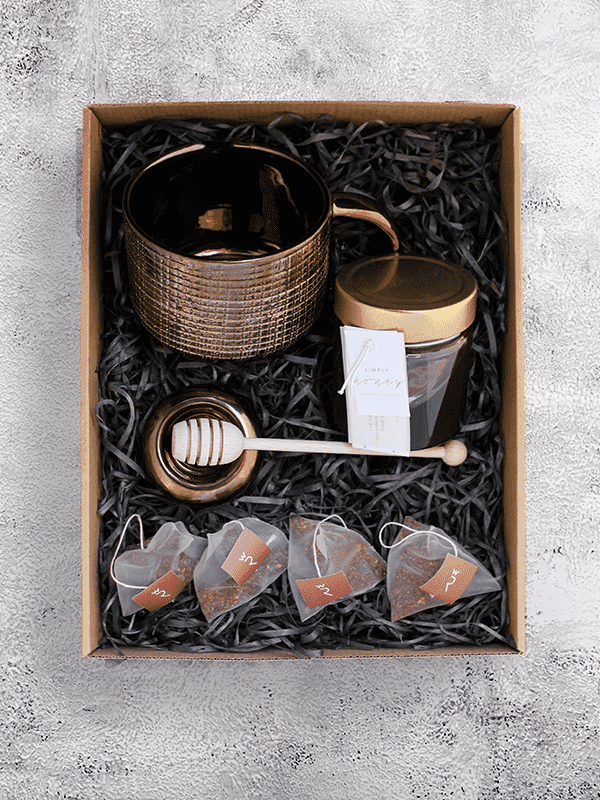 Handcrafted giant tea cup set with South African honey, wooden dipper, ceramic rest, and organic Wupperthal Rooibos tea bags.