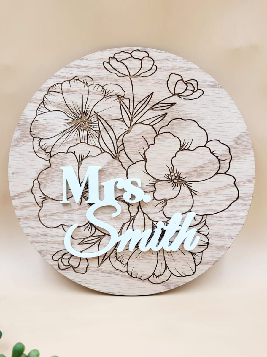 Personalised floral wooden plaque with "Mrs. Smith" engraving, crafted from oak veneer with laser-cut floral details.