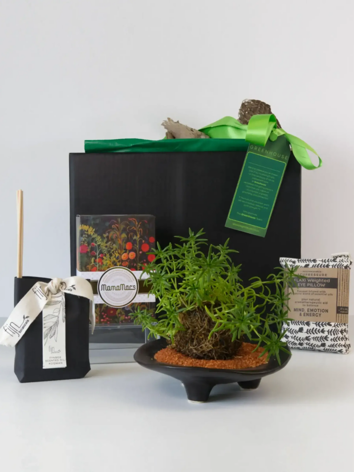 Kokedama plant gift set with black ceramic bowl, green herbs, premium gift box with green ribbon, wellness tea sachets, and MamaMacs branded packaging for mindful gifting.