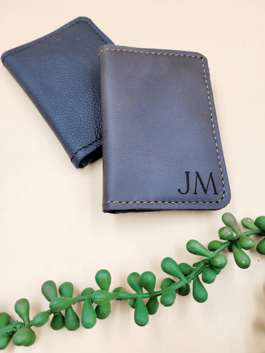 Personalised men's leather bi-fold wallet with initials, showcasing sleek design and premium craftsmanship against a neutral background.