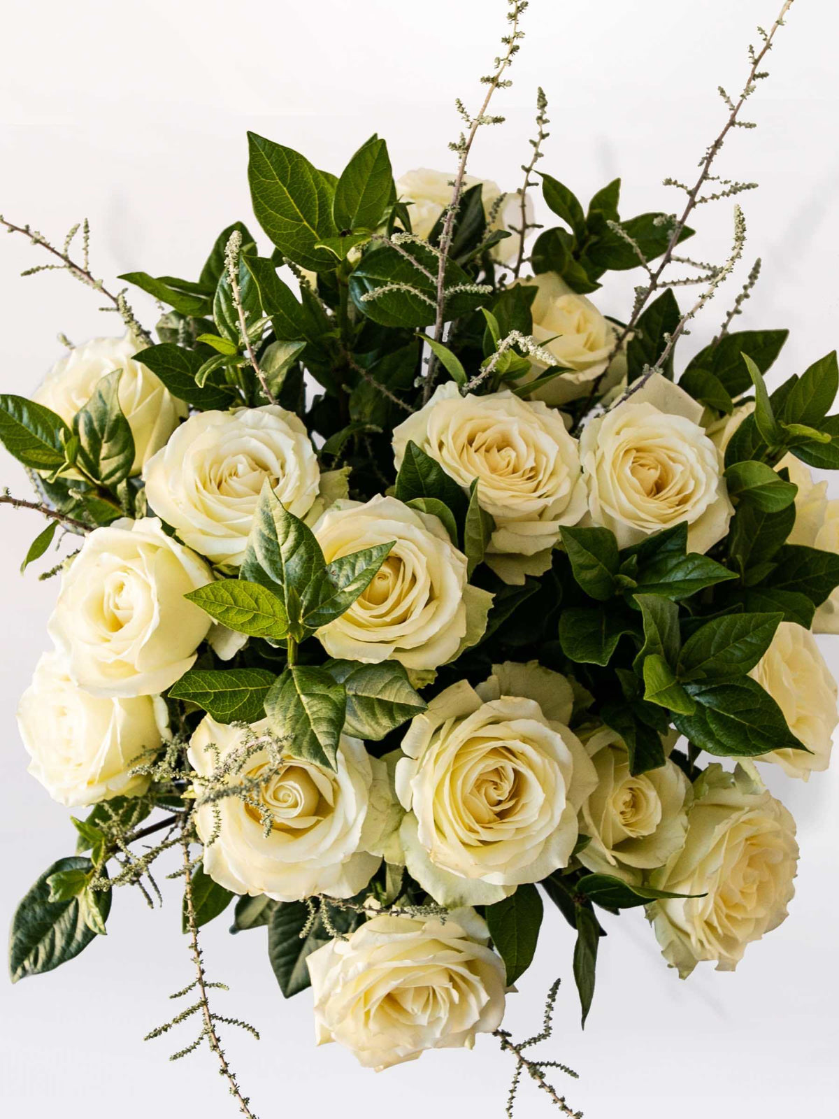 Elegant white rose bouquet with greenery, perfect for special occasions. Seasonal variations may occur. Support local South African florists.