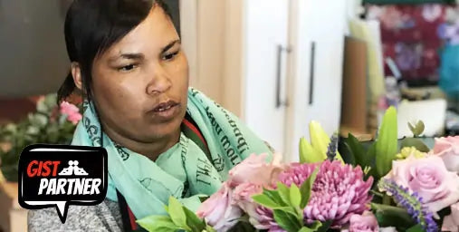 Person arranging flowers with a 'GIST Partner' logo in the corner