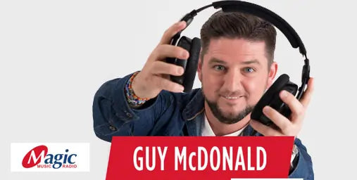 Man holding headphones with 'Magic Radio' and 'Guy McDonald' text on a white background