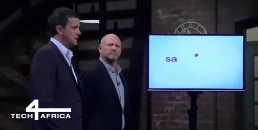Two men standing in front of a screen displaying 'sa' on a dark background with 'Tech4Africa' branding.
