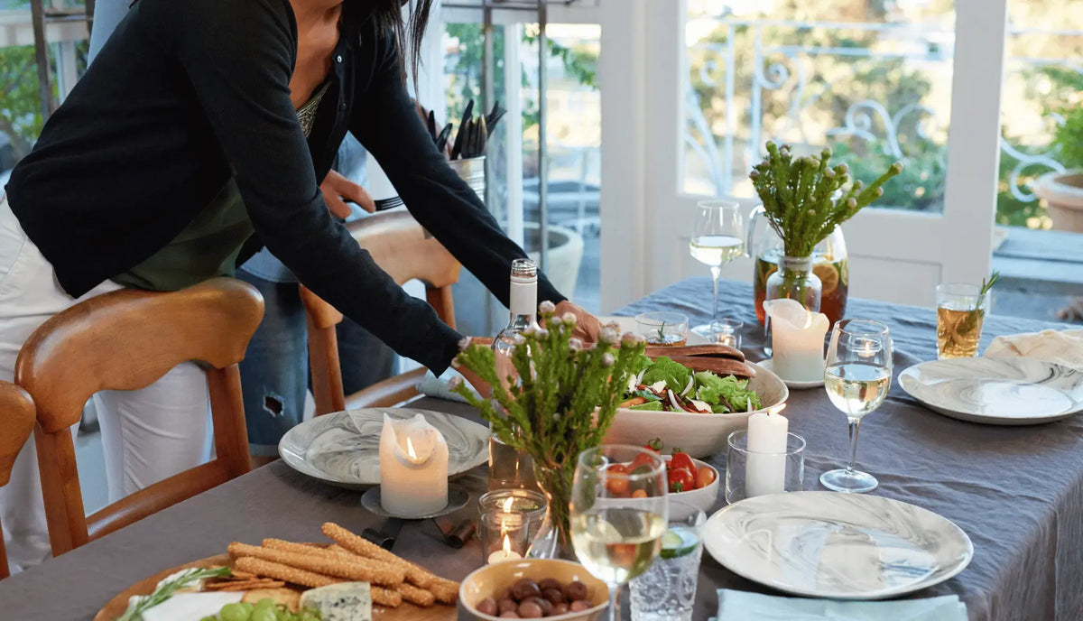 host is laying table for new years party 