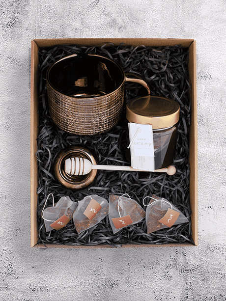 Handcrafted giant tea cup set with South African honey, wooden dipper, ceramic rest, and organic Wupperthal Rooibos tea bags.