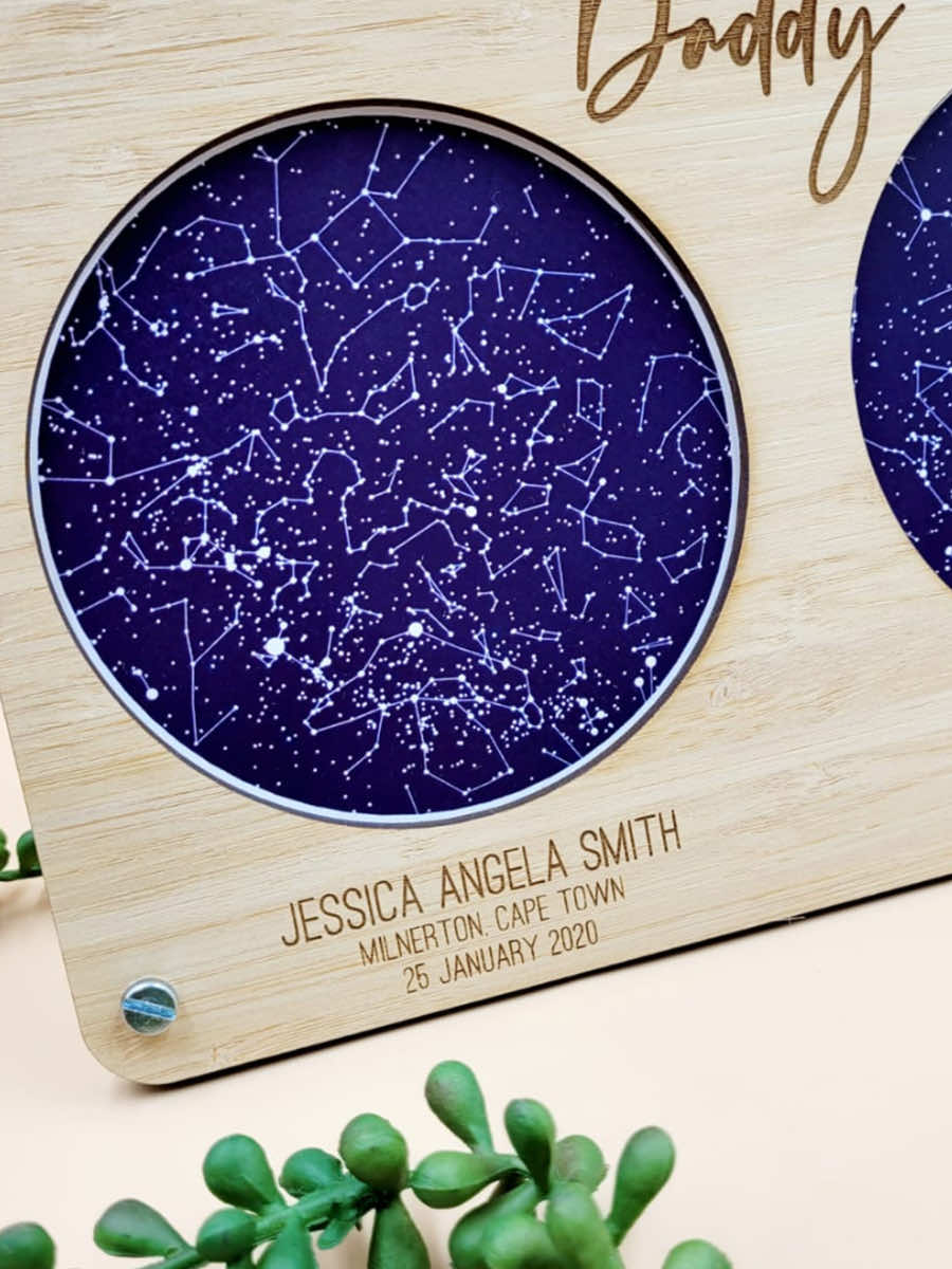 Personalised wooden framed star map with engraved dedication and visible constellation design on a blue background.