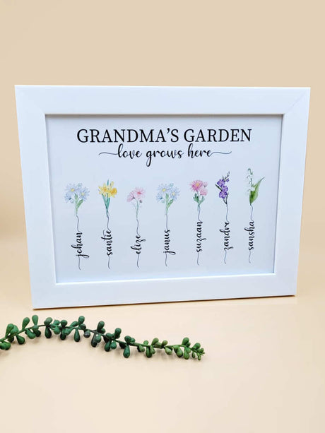 Framed personalised birth month flower art print labeled 'Grandma's Garden' with names and flowers.