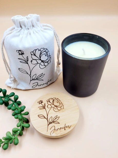 Candle with matching drawstring bag and coaster featuring floral designs on a beige background