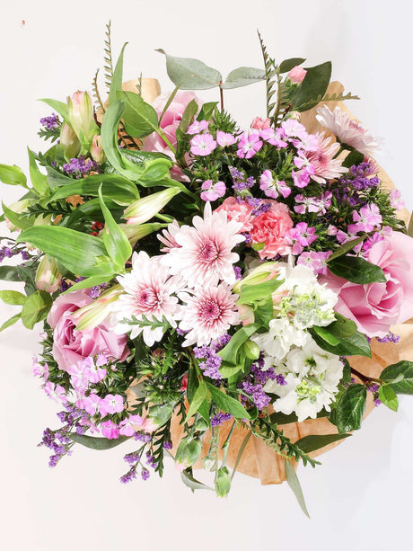 Celebration of Kindness bouquet featuring pink and white flowers, symbolizing kindness and healing.