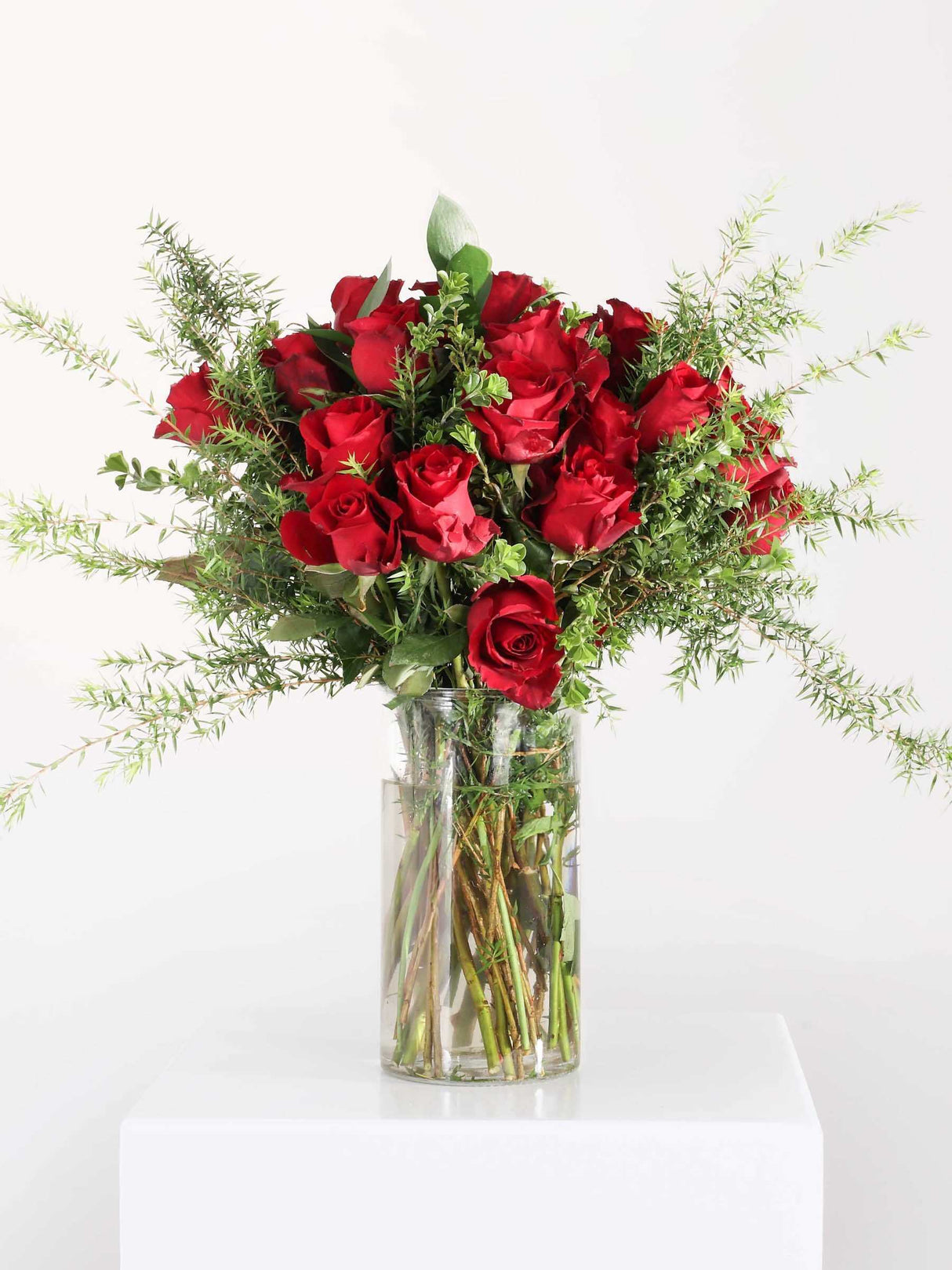 Beautiful classic red rose bouquet in a clear vase, perfect for romantic occasions and Valentine's Day.