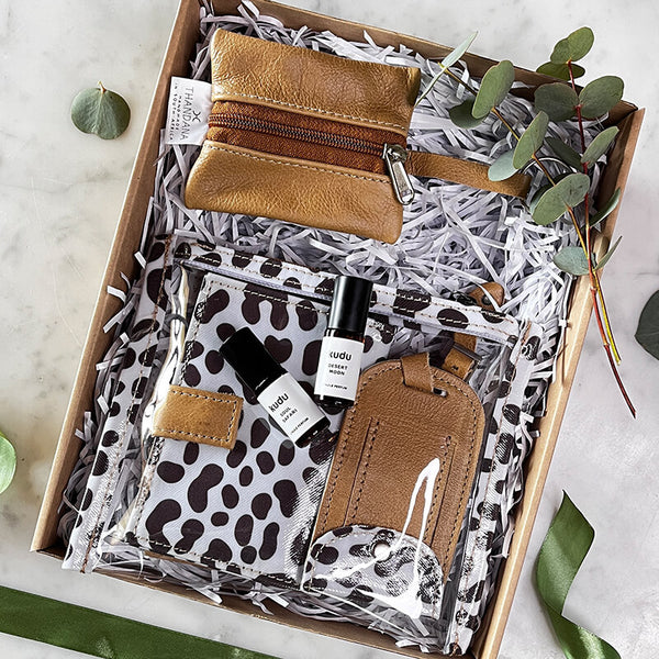Essence of the Wild gift set featuring travel accessories and Desert Moon and Soul Safari perfumes in elegant packaging.