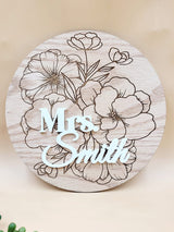 Personalised floral wooden plaque with "Mrs. Smith" engraving, crafted from oak veneer with laser-cut floral details.