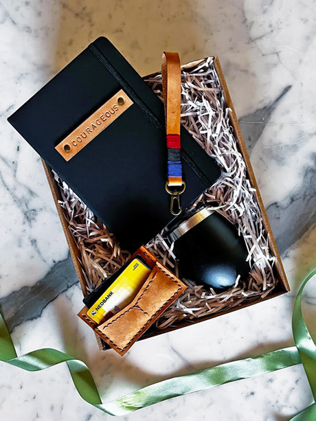 Forge Ahead gift set with leather wallet, key ring strap, thermal cup, and A5 journal, ideal for those embracing challenges.