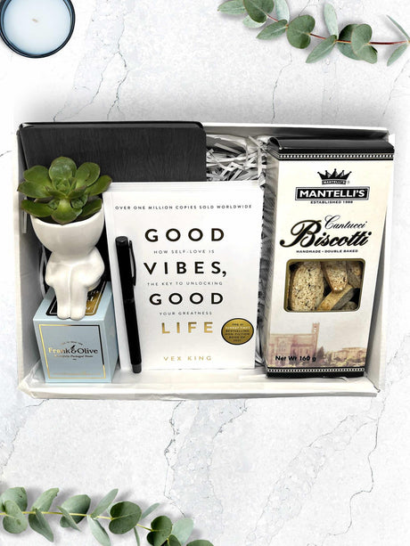 Unique gift box with 'Good Vibes, Good Life' by Vex King, journal, pen, and treats ideal for goal-setters and growth-focused individuals.