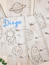 Personalised wooden kids growth chart with space theme, featuring a custom name in blue acrylic and height measurements. Perfect nursery decor.