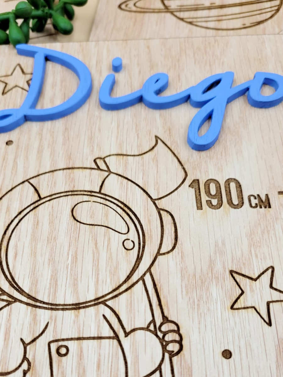 Personalised kids growth chart with engraving, blue acrylic name "Diego," astronaut and star design, made from veneer wood.