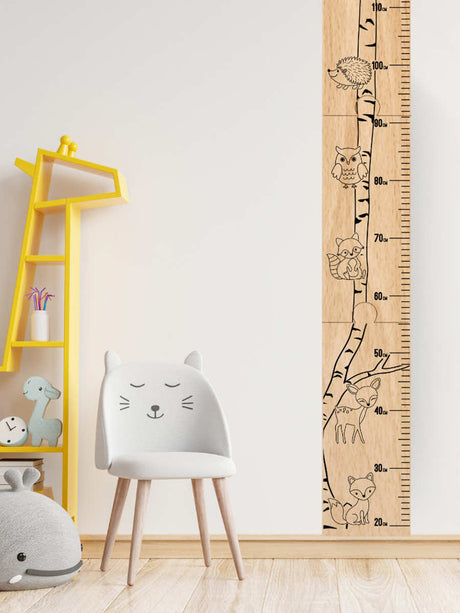 Veneer wood personalised kids' growth chart in nursery with animal drawings, adding a fun touch to track children's height milestones.
