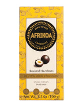 Afrikao chocolate bar packaging with roasted hazelnuts on a white background