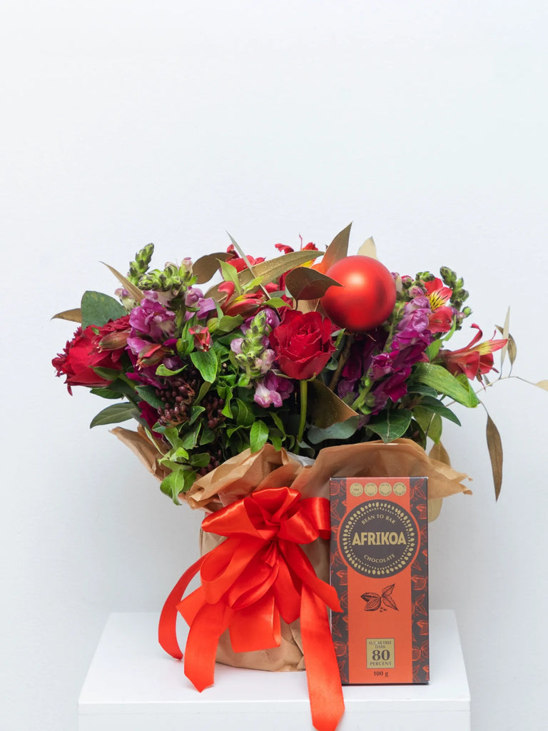 Christmas flower gift set with red roses, purple stocks, Afrikoa chocolate and red bauble - luxury festive hamper with ribbon