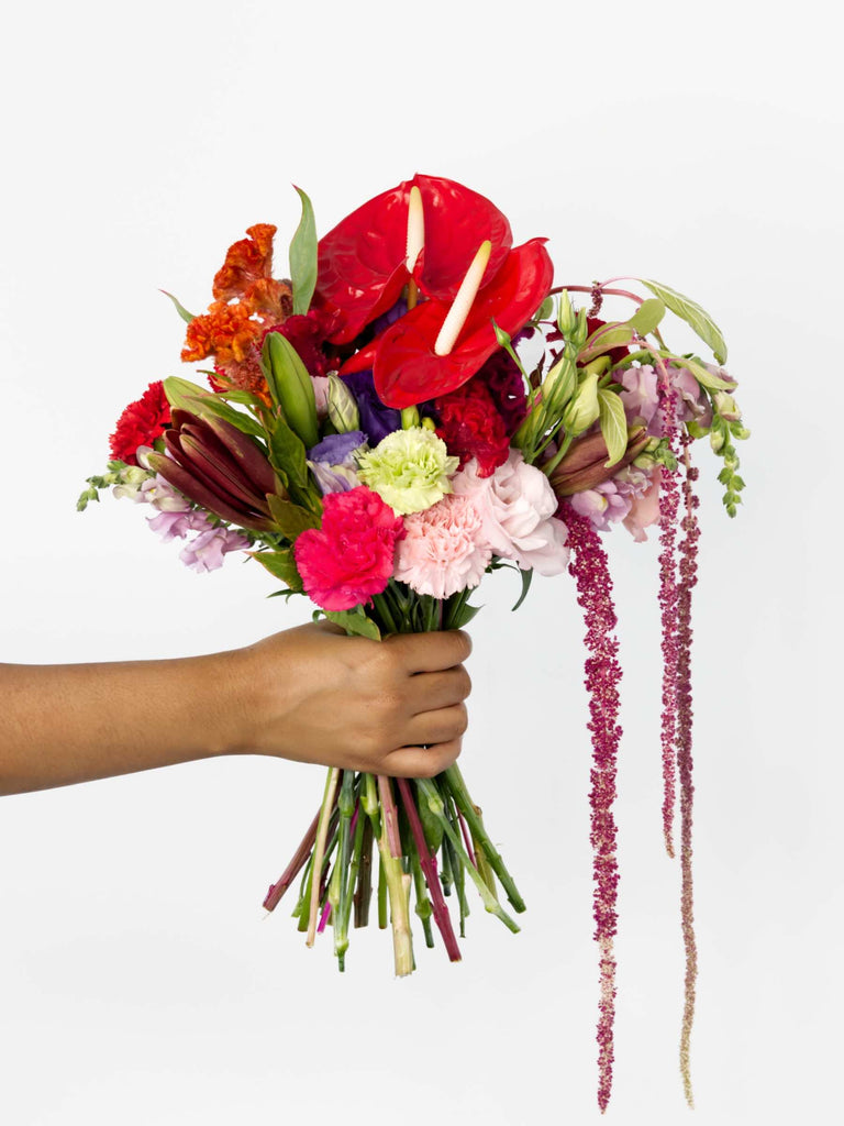 Just As You Are bouquet featuring vibrant lilies, carnations, and cockscomb, hand-held for a charmingly romantic presentation.