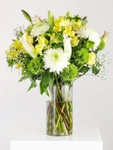 Large yellow and white flower bouquet with white chrysanthemums, yellow lilies, yellow alstroemeria, green dianthus and baby's breath in clear glass vase - fresh luxury arrangement