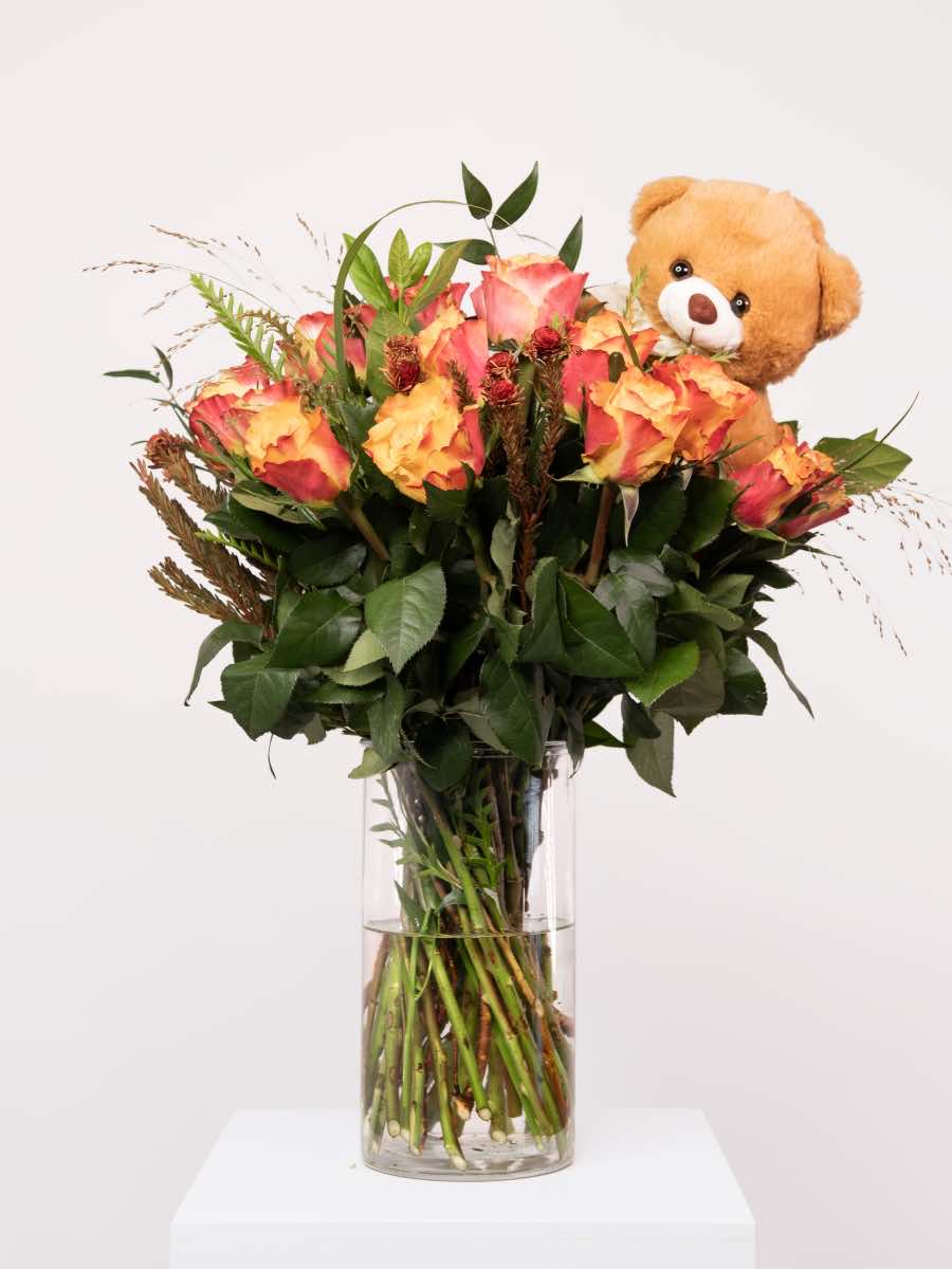 Orange rose bouquet with teddy bear, ideal Valentine's Day gift, featuring cheerful blooms and a cute plush, available in 8, 16, or 24 roses.