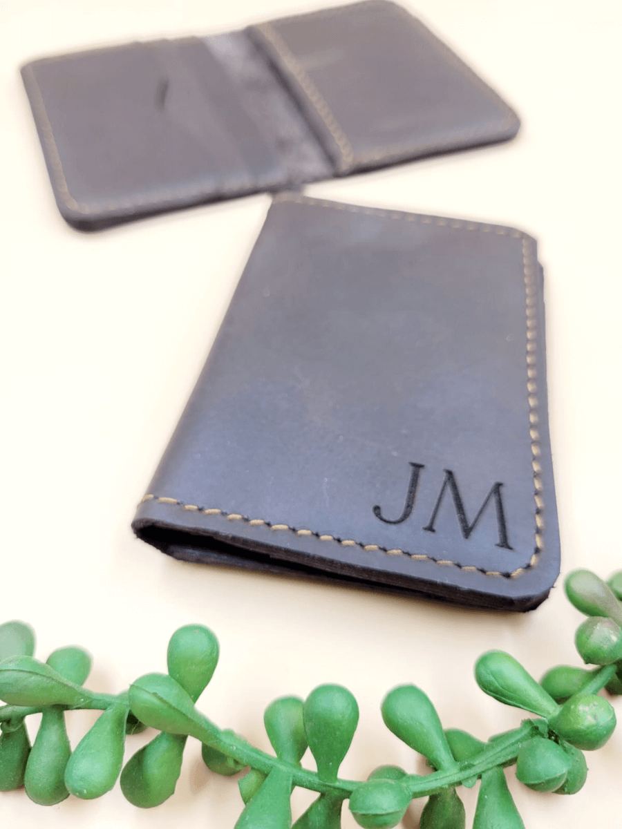 Personalised men's leather bi-fold wallet with initials, handcrafted from premium leather, showcasing sleek design and quality stitching.