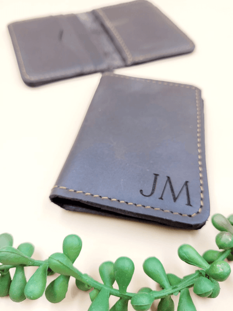 Personalised men's leather bi-fold wallet with initials, handcrafted from premium leather, showcasing sleek design and quality stitching.