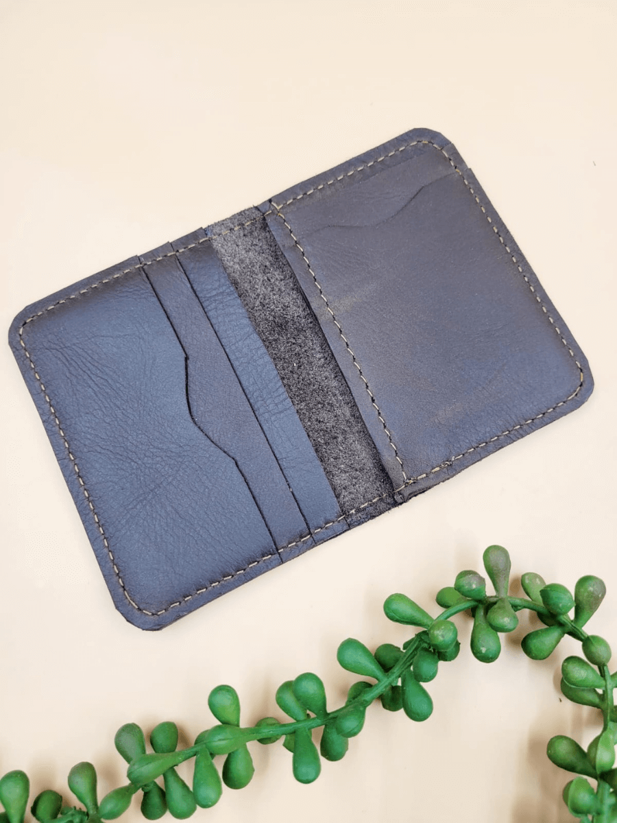 Open view of a personalised men's leather bi-fold wallet, showcasing multiple card slots and sleek design, handcrafted from premium leather.