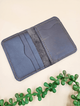 Open view of a personalised men's leather bi-fold wallet, showcasing multiple card slots and sleek design, handcrafted from premium leather.
