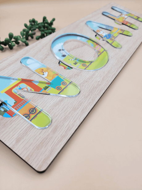 Personalised name puzzle for kids with acrylic letters on oak veneer, featuring a colorful themed background, perfect for learning and play.