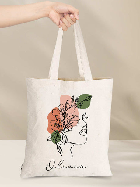 Personalised cotton tote bag with floral design and 'Olivia' text, eco-friendly with long handles, ideal for everyday use and gifts.