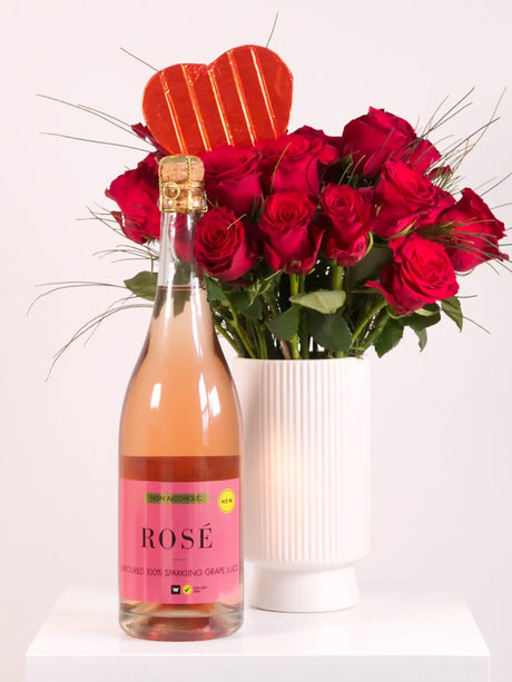 Bottle of Rosé wine with a bouquet of red roses on a white background
