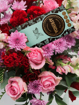 Bouquet of flowers with a box of chocolates on top