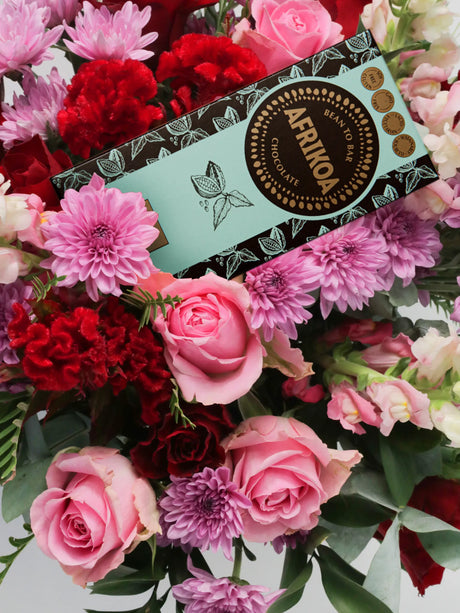 Bouquet of flowers with a box of chocolates on top