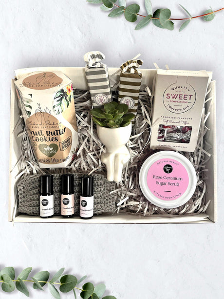 Sweet Escape Set for Her with scented rollers, caramel toffee, bon bons, vegan cookies, sugar scrub, succulent, and crochet cloth.