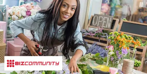 Woman arranging flowers in a floral shop with 'BizCommunity' logo.