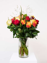 Alt text:
"Bloomable's Mixed Roses bouquet in a clear glass vase on a white pedestal. Features an elegant arrangement of deep red roses, bright yellow roses, and sunset orange-yellow bicolour roses with delicate grasses and rich green foliage. Perfect for Mother's Day, Valentine's Day, anniversaries, or expressing warm emotions with same-day delivery across South Africa.