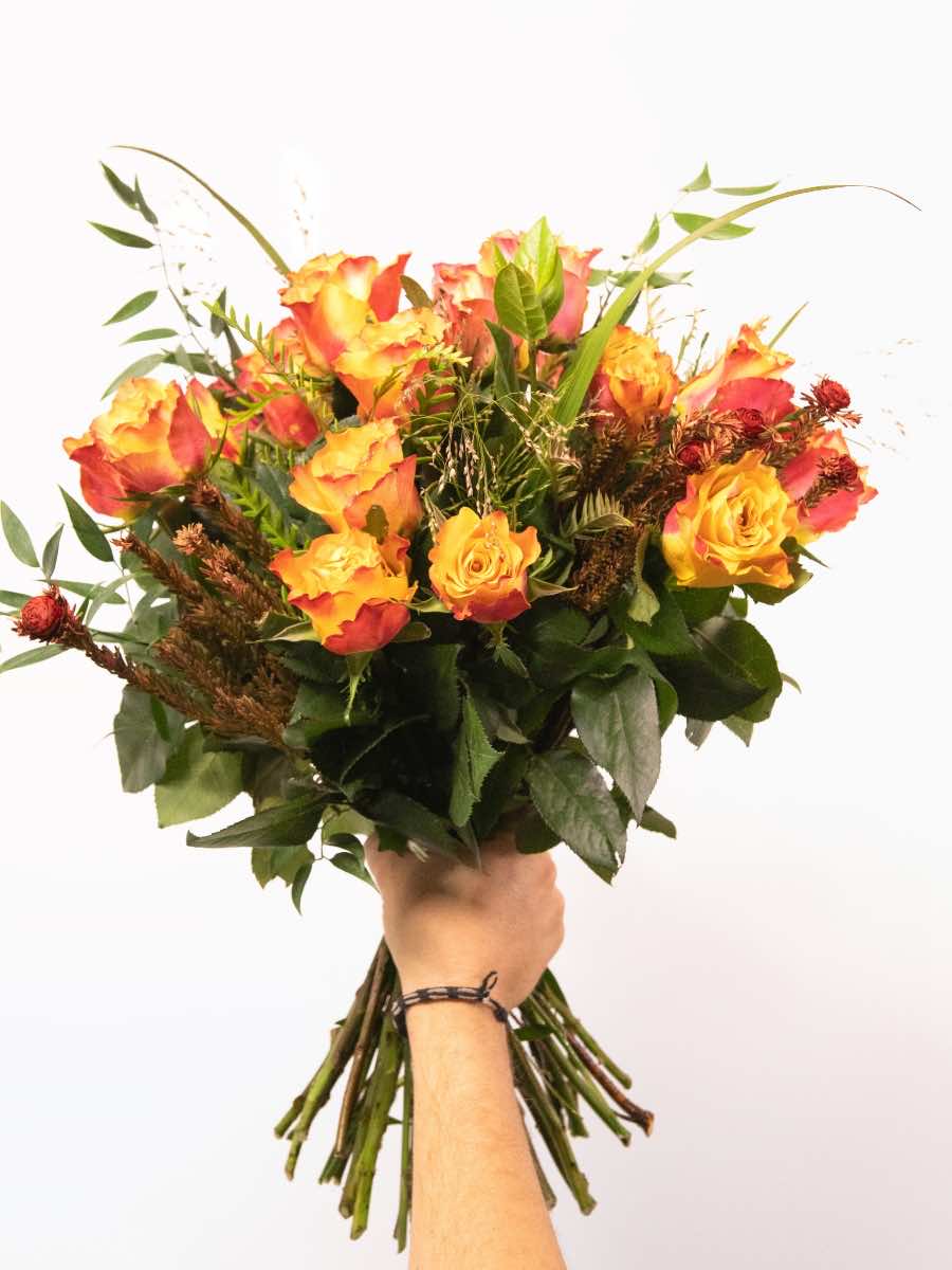 Vibrant orange rose bouquet with greenery, hand-tied by local South African florists, showcasing seasonal floral beauty and craftsmanship.