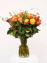 Elegant orange rose bouquet with lush greenery in a glass vase, crafted by South African florists. Image of Heart & Soul floral arrangement.