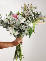 Hand-held white and pink flower bouquet with white alstroemeria, pink roses, eucalyptus and waxflower showing size - fresh romantic gift bouquet