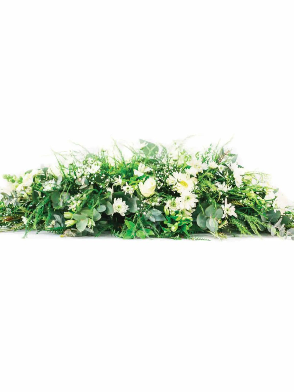 Coffin or Casket Spray of mixed seasonal flowers and greenery for memorial and funeral services.