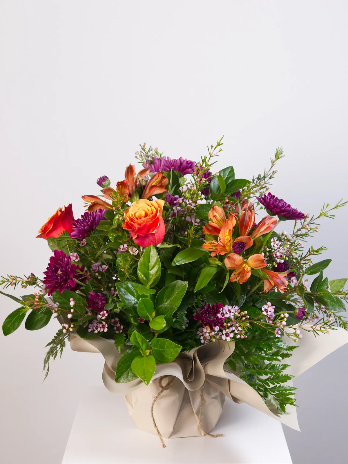  Vibrant mixed posy with orange roses, alstroemeria and purple chrysanthemums