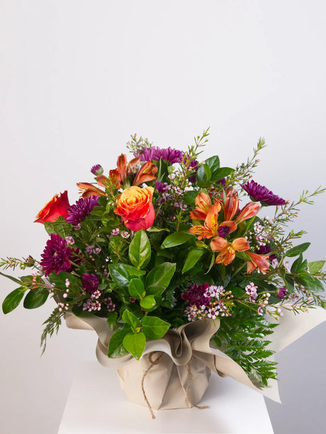  Vibrant mixed posy with orange roses, alstroemeria and purple chrysanthemums