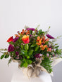  Vibrant mixed posy with orange roses, alstroemeria and purple chrysanthemums