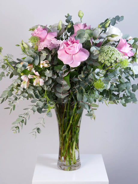 Large pink lisianthus, alstroemeria and eucalyptus bouquet in trumpet glass vase