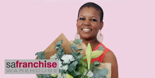 Woman holding a bouquet of flowers with 'safranchise Warehouse' logo on a pink background