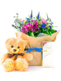 Gift set with colorful flowers, plush teddy bear, and Lindt chocolate, perfect for celebrating the birth of a baby boy.