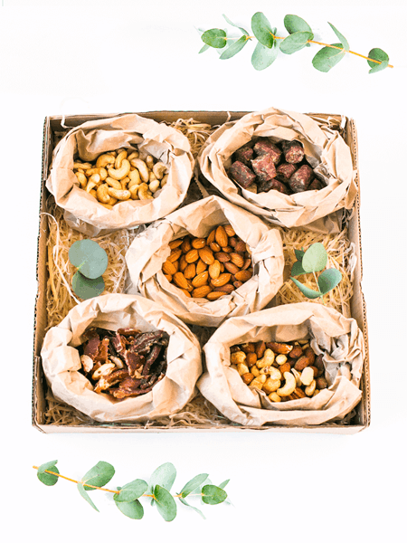 Biltong and Nuts Snack Box featuring almonds, cashews, mixed nuts, sliced biltong, and dried wors presented beautifully in a gift box.